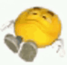 a yellow smiley face with arms and legs is laying down on a white surface .