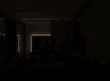 a dark room with a picture on the wall