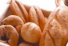 a basket filled with a variety of breads and pastries .