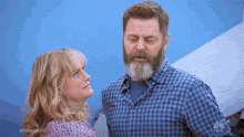 a man with a beard and a woman looking at each other with #makingit on the bottom