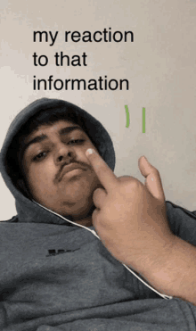 a man wearing a hoodie is giving the middle finger with the words " my reaction to that information " below him