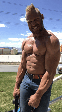 a shirtless man with a beard is smiling and holding a pole