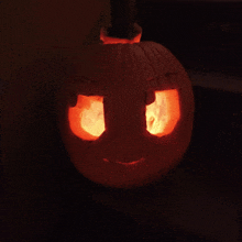 a pumpkin with a face carved into it glows brightly in the dark