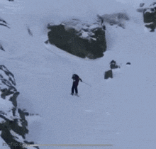 a person is skiing down a snow covered hill