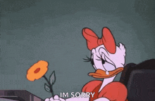 daisy duck is sitting on a couch holding a flower and saying `` im sorry '' .