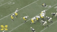 a blurred image of a football game with the word michigan on the bottom right