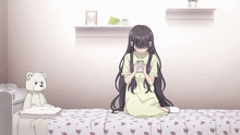 a girl sits on a bed with a teddy bear in the background