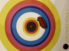 a red toy car is in the center of a rainbow colored circle