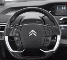 a close up of a steering wheel in a car with a citroen logo on it