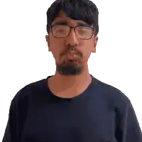 a man with a beard wearing glasses and a black shirt