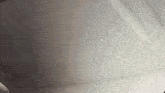 a close up of a white surface with a shadow on it .