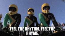 a group of people wearing motorcycle helmets are standing next to each other in a row .