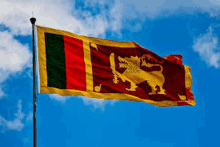 the flag of sri lanka is flying in the wind against a blue sky