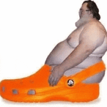 a fat man is wearing a large orange croc shoe .