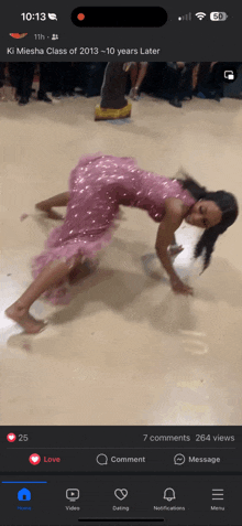 a girl in a pink dress is dancing on the floor