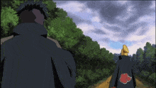 a man in a black cape with a red cloud on the back