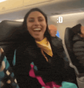a woman is sitting on an airplane with a smiley face and the letter d above her