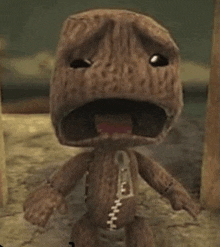 a wooden toy with a zipper on its chest is standing on a dirt ground .