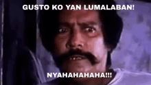 a man with a mustache is making a funny face with the words gusto ko yan lumalaban