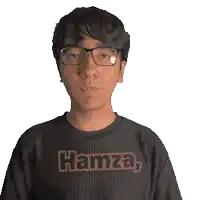 a man wearing glasses and a hamza shirt