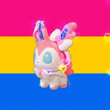 a stuffed animal is sitting on a pink yellow and blue flag