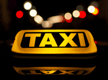 a taxi sign is lit up at night