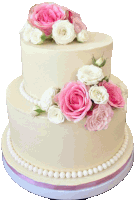 a white cake with pink and white flowers and pearls