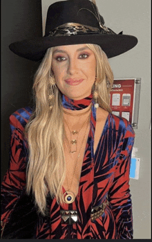 a woman wearing a cowboy hat and a zebra print top