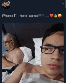 a man with glasses is laying in bed with an older man with glasses