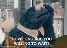 a cookie monster sitting at a table with the words how long are you willing to wait on the bottom