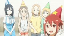 a group of anime girls wearing party hats standing next to each other .