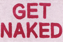 a towel that says get naked in red letters