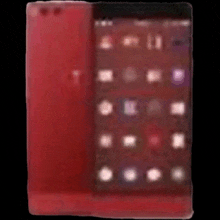 a blurred image of a red phone with a black background .