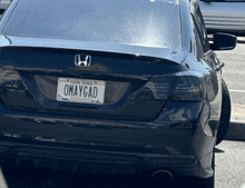 a black honda has a new york license plate that says omaygad