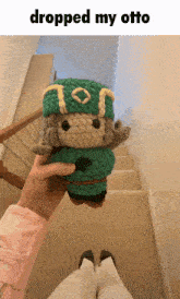 a person holding a stuffed animal that says dropped my otto on it