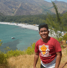 a young man wearing a red shirt that says ' sgvca ' on it