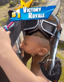 a person wearing a helmet with a victory royale sign on it