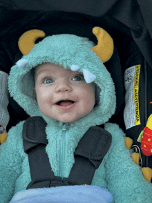 a baby wearing a monster costume with a warning label on it