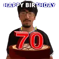 a man with glasses is holding a birthday cake with candles in the shape of the number 70