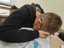 a man is laying down with his head on a book that says london on it