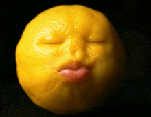 a lemon with its eyes closed and pink lips making a face