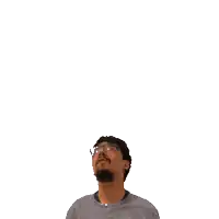 a man with glasses looks up at the number twelve