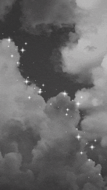 a black and white photo of clouds and stars in a dark sky