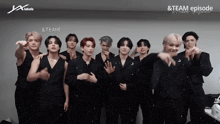 a group of young men are posing for a photo and one of them says team