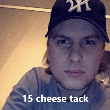 a man wearing a ny yankees hat has 15 cheese tack written below him