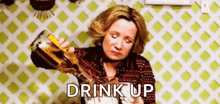 a woman is pouring a bottle of liquor into a glass .