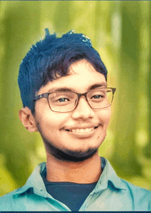 a young man wearing glasses is smiling for the camera