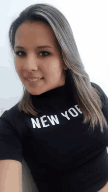 a woman wearing a black shirt with the word new york on it