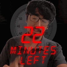 a man in front of a clock that says 22 minutes left on it