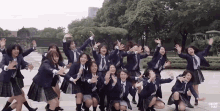 a group of girls in school uniforms are posing for a picture with drop hat written on the bottom right